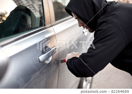 Car thief steal car breaking door criminal job burglar Hijacks Auto thief in black wear Car thief steal car breaking door criminal job burglar Hijacks Auto thief in black wear 82264689