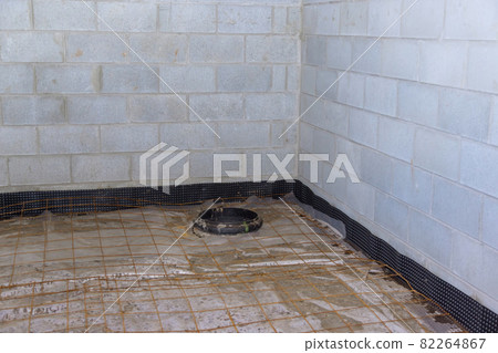 Unfinished view on concrete floor construction of basement empty under construction of home 82264867