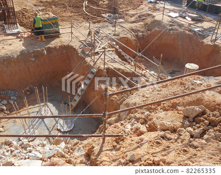 PENANG, MALAYSIA -SEPTEMBER 2, 2021: The process of cutting piles after the completion of building foundation piling work. This work needs to be done before the construction of the cap pile is proceed 82265335