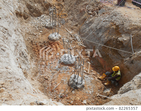 PENANG, MALAYSIA -SEPTEMBER 2, 2021: The process of cutting piles after the completion of building foundation piling work. This work needs to be done before the construction of the cap pile is proceed PENANG, MALAYSIA -SEPTEMBER 2, 2021: The process of cutting piles after the completion of building foundation piling work. This work needs to be done before the construction of the cap pile is proceed 82265357