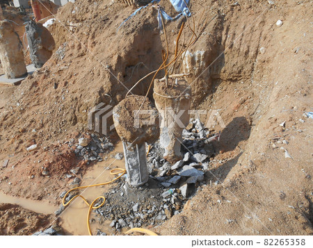 PENANG, MALAYSIA -SEPTEMBER 2, 2021: The process of cutting piles after the completion of building foundation piling work. This work needs to be done before the construction of the cap pile is proceed 82265358