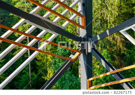 a fragment of the structure of a new modern metal observation tower with decorative wooden elements 82267175