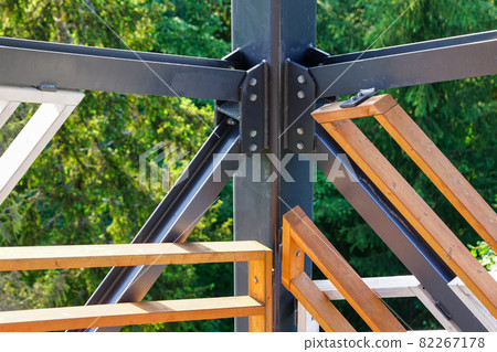 a fragment of the structure of a new modern metal observation tower with decorative wooden elements 82267178