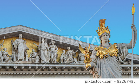 Athena statue at fountain (Pallas-Athene-Brunnen) in front of the Parliament, an ancient Greek goddess for victory and warfare at blue sky in Vienna, Austria, details, closeup. 82267483