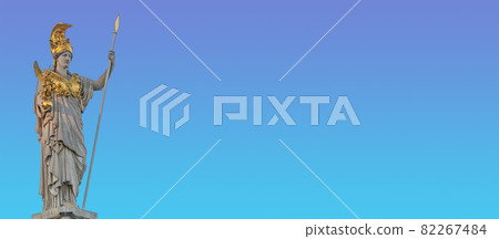 Banner with Athena statue at fountain (Pallas-Athene-Brunnen) in front of the Parliament, an ancient Greek goddess for victory and warfare at blue sky in Vienna, Austria, with copy space for text. 82267484