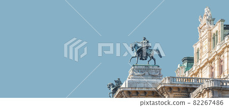 Banner with top roof sculpture of Greek goddess Muse riding Pegasus, a winged horse, at Vienna State Opera House, Vienna, Austria, with copy space. Concept of Cultural Heritage and Travel. 82267486