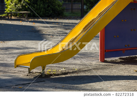 Yellow slide in the park on an autumn morning Yellow slide in the park on an autumn morning 82272318