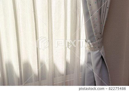 Thin lace fabric curtains covering the windows Thin lace fabric curtains covering the windows 82275486