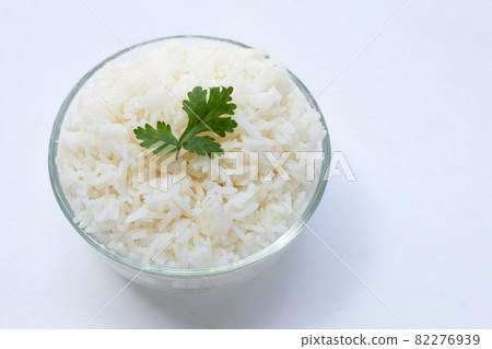 Glass bowl of rice on white background. Glass bowl of rice on white background. 82276939