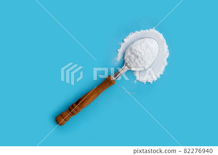 Baking soda on blue background. Baking soda on blue background. 82276940