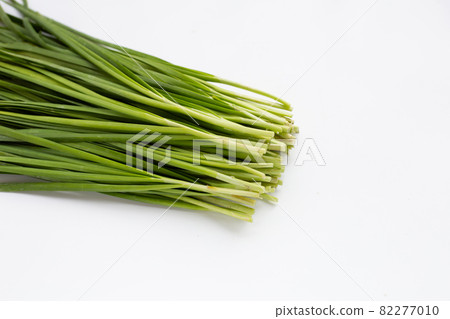 Fresh Chinese Chive leaves on white background. Fresh Chinese Chive leaves on white background. 82277010
