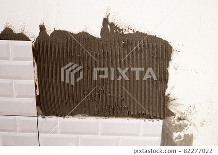 House renovation, Laying ceramic tles on the wall. 82277022