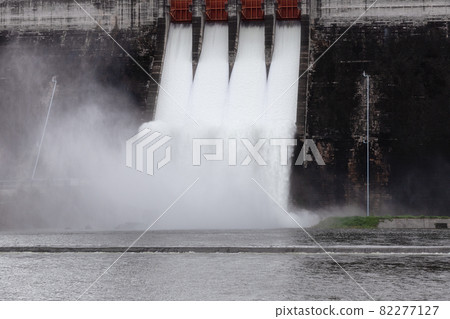 Water flowing over floodgates of a dam at Khun Dan Prakan Chon, Nakhon Nayok 82277127