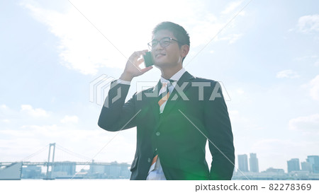 Businessmen talking on a smartphone Businessmen talking on a smartphone 82278369