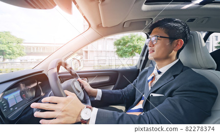 A man driving a car 82278374