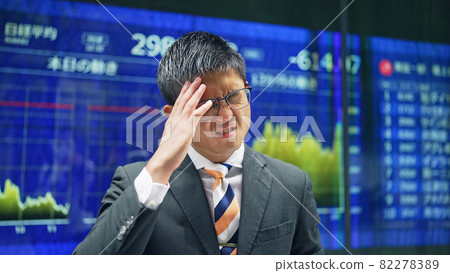A depressed man in front of a stock board A depressed man in front of a stock board 82278389