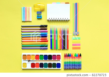 Painting supplies on a colored background. Set of first grader on a yellow background. Office supplies in a layout on a yellow paper background. Flat layout 82278723