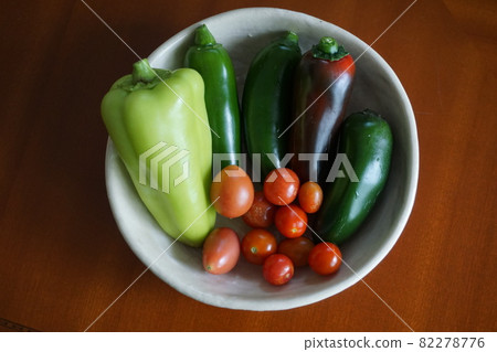 Harvesting bell peppers and cherry tomatoes 82278776