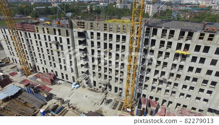 Unfinished apartment complex with builders on the top, aerial 82279013