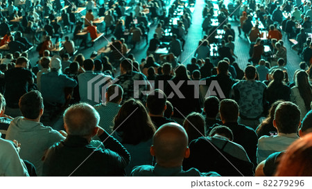 People watching football in a public place at night 82279296