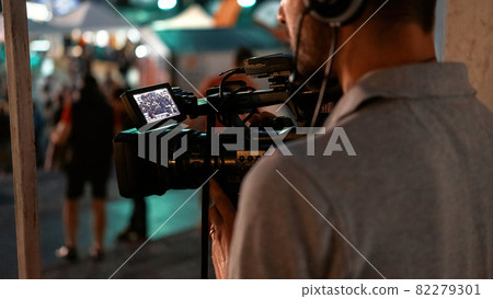 Cameraman recording poeple watching football Cameraman recording poeple watching football 82279301