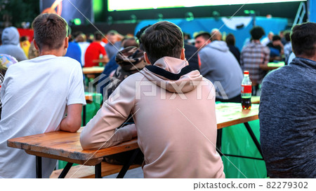 People watching football in a public place People watching football in a public place 82279302