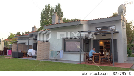 Tenant Resting on the Backyard of Rented House 82279568