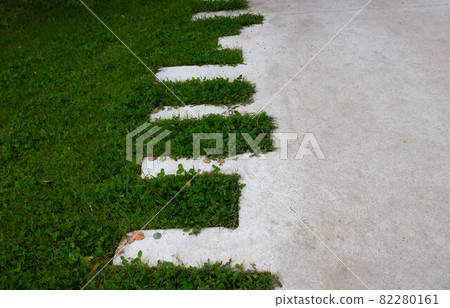 Green lawn and concrete zigzag path in the park Green lawn and concrete zigzag path in the park 82280161