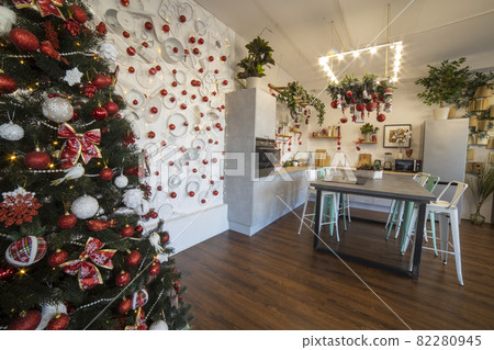 interior of a cozy modern spacious kitchen for a large family, decorated for the New Year celebration interior of a cozy modern spacious kitchen for a large family, decorated for the New Year celebration 82280945