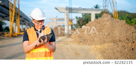Asian worker using digital tablet at construction site 82282135