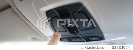 Man with his finger pressing emergency button in car closeup 82283004