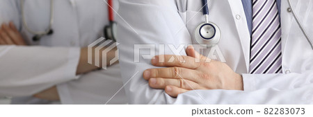 Doctors with stethoscopes around their necks are standing with arms crossed closeup Doctors with stethoscopes around their necks are standing with arms crossed closeup 82283073