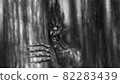 Scary mister Halloween looks out from behind tree in dark forest. Gloomy evil demon. Spooky 2d illustration. 82283439