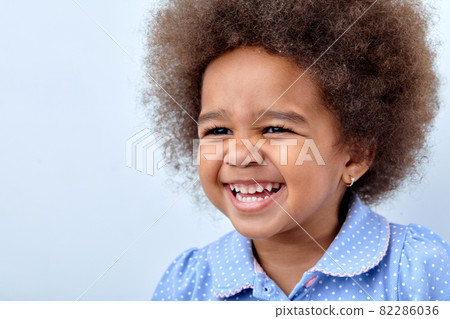 Funny little adorable African american child girl looking at side, having fun 82286036