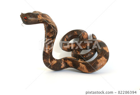 Souvenir figurine of a large cobra (tree), isolated on white Souvenir figurine of a large cobra (tree), isolated on white 82286394