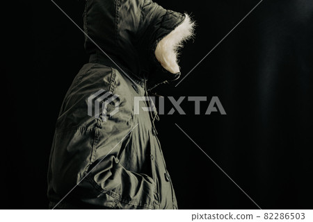 Person wearing a hood 82286503