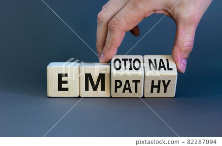 Emotional empathy symbol. Doctor turns wooden cubes and changes the word 'Emotional' to 'Empathy'. Beautiful grey table, grey background, copy space. Psychology, emotional empathy concept. 82287094
