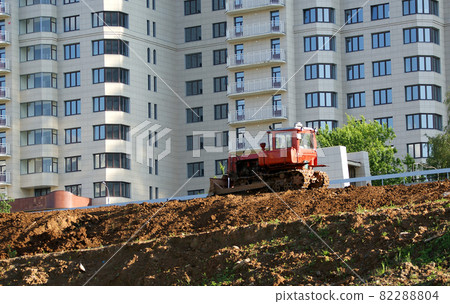 Heavy buildind tractor in front of building site , Moscow, Russia 82288804