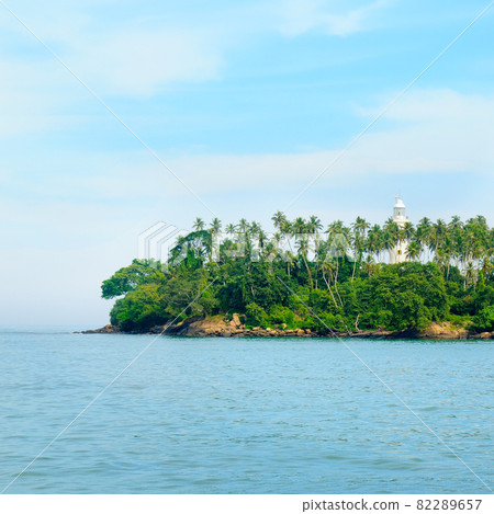 Lighthouse and turquoise ocean . Sri Lanka . Concept - vacation and travel. Lighthouse and turquoise ocean . Sri Lanka . Concept - vacation and travel. 82289657