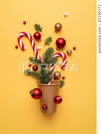Christmas card with holiday decorations on yellow background Christmas card with holiday decorations on yellow background 82290772