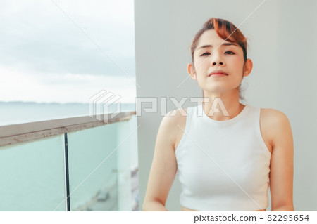 Close up of woman relax on the hotel balcony with sea view in summer. Close up of woman relax on the hotel balcony with sea view in summer. 82295654