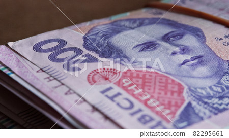 Portrait of Lesya Ukrainka in 200 hryvnia banknotes. Ukrainian paper bank notes, close-up. Portrait of Lesya Ukrainka in 200 hryvnia banknotes. Ukrainian paper bank notes, close-up. 82295661