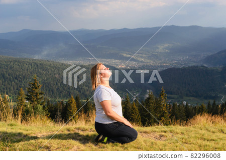Beautiful woman among nature. Relaxation in the hills and forests. High in the mountains. Beautiful woman among nature. Relaxation in the hills and forests. High in the mountains. 82296008