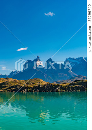 Peaks of Torres seen from Pehoe Lago with turquoise water in Torres del Paine National Park, Patagonia, Chile, at sunny day and blue sky. 82296740