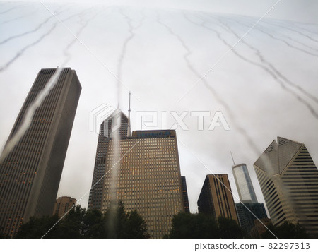 Creative reflection of skyscrapers in a mirrored installation with water tricles on a rainy day in Chicago  82297313