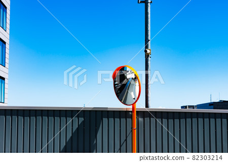 Curved mirror and blue sky in a multi-storey car park Curved mirror and blue sky in a multi-storey car park 82303214