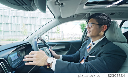 A man driving a car 82303884