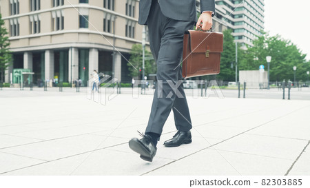 Businessman walking on the road Businessman walking on the road 82303885