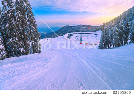 Ski slopes with cable cars at sunrise, Poiana Brasov, Romania 82305809