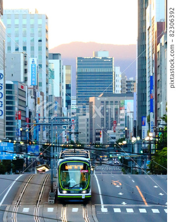 Hiroshima Electric Railway and trams running in Hiroshima City when the rising sun rises Hiroshima Electric Railway and trams running in Hiroshima City when the rising sun rises 82306392